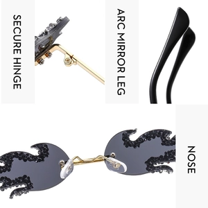 Detail view of luxury flame sunglasses featuring secure hinges and rhinestone accents