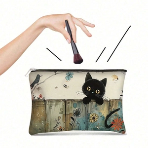 Detail of artistic black cat and floral canvas bag with metal zipper and makeup brushes