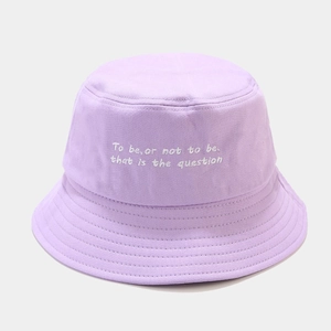 Close-up of lavender bucket hat featuring white Shakespearean embroidery on cotton