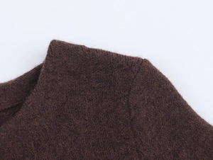 Close-up of dark brown knit fabric with faux fur stitching and texture details