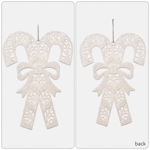 Macro view of white glitter Christmas candy cane ornaments with bow and hollow patterns