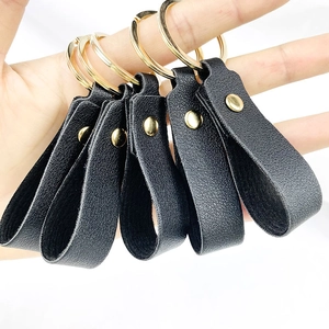 Set of five minimalist black PU leather keychains with golden metal rings and rivets