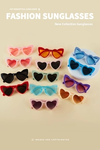 Flat lay of colorful heart-shaped sunglasses in multiple vibrant fashion colors