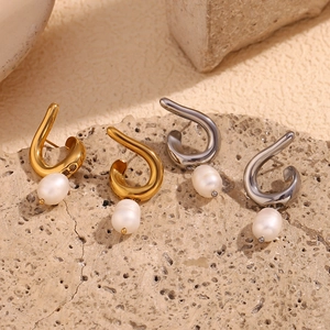 Detail of minimalist 18K gold and silver plated spiral wire earrings with oval pearls