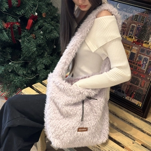 Detail of soft purple faux fur tote bag showing fluffy texture and side drawstring design