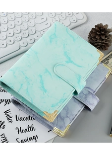 Detail of A6 marble PU leather binders in cyan and purple with gold metal corners
