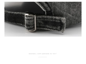 Detail of adjustable metal buckle on washed denim baseball cap with vintage finish