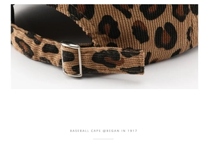 Detailed macro of leopard print corduroy baseball cap with adjustable metal sliding buckle