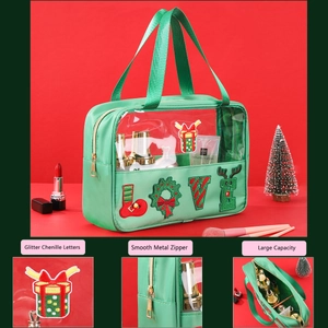 Detail of green Christmas makeup bag with glitter chenille letters and metal zipper