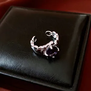 Retro liquid metal style silver ring with a large oval purple gemstone setting