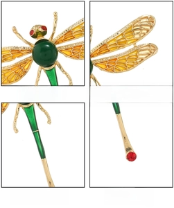 Macro view of gold dragonfly brooch featuring green faux-jade body and detailed resin wings