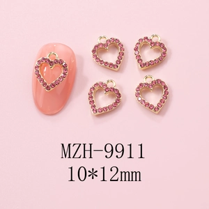 Detail of pink rhinestone heart nail charms with golden alloy frame in 10x12mm size