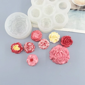 Macro view of flexible silicone rose and peony molds with colorful DIY flower samples