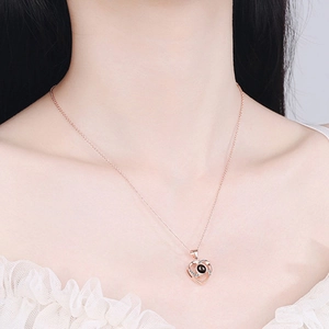 Rose gold 925 sterling silver heart projection necklace with black gemstone on model