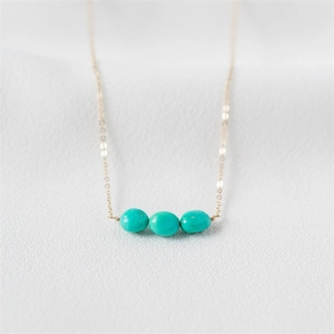 Minimalist 14K gold plated necklace featuring three oval turquoise stones on a fine chain