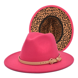 Detail of wide brim fedora hat in dark pink with camel leather strap and leopard print underbrim