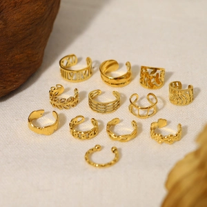 Set of 12 adjustable 18K gold plated vintage French style ear cuffs on a textured cloth