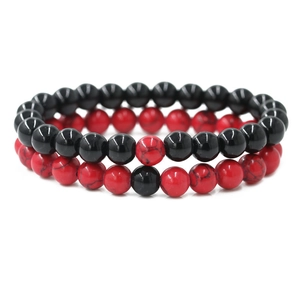 Pair of 8mm black and red stone beaded distance bracelets for couples on white background