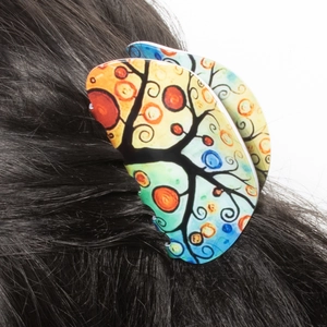 Artistic Tree of Life hair claw clip with colorful floral pattern on black hair
