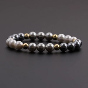 Close-up of beaded bracelet with colorful pearl beads and golden metallic accents