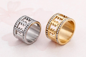 Detail of couple rings with boy and girl silhouettes, gold and silver plated with crystals