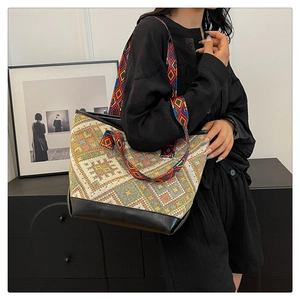 Detailed side view of ethnic tote bag with woven geometric patterns and PU leather base