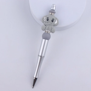 Close-up of a silver beaded pen with a gray cartoon elephant topper and rhinestone rings