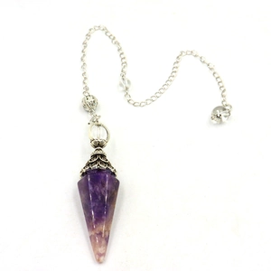 Detailed macro of a purple amethyst hexagonal crystal pendulum with silver flower cap