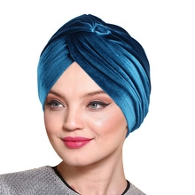 Close-up of royal blue velvet turban headwrap featuring a soft textured finish on a model