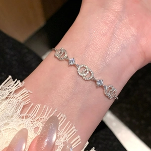 Detailed close-up of 18k gold plated silver bracelet with sparkling zircon on a wrist