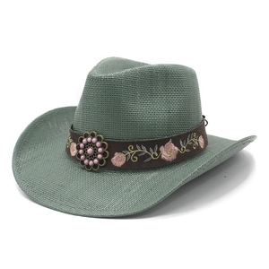 Close-up of bean green straw cowboy hat with floral embroidery and beaded decoration
