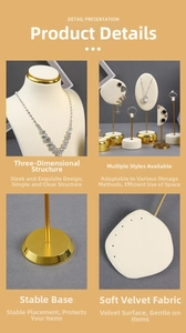 Detail of cream velvet jewelry display stand with golden metal base and sturdy structure