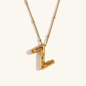 Close-up of 18K gold plated bead chain with a puffer style metal letter Z pendant