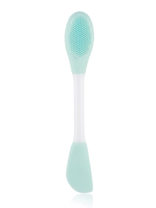 Dual-ended silicone face brush with mint green bristles and white spatula for facial care