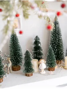 Miniature flocked Christmas trees with reindeer, angel, and LED lights on wood base