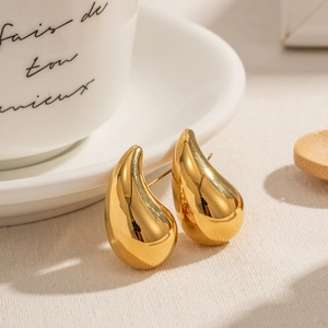 Minimalist gold-plated chunky hollow teardrop earrings on a chic lifestyle background