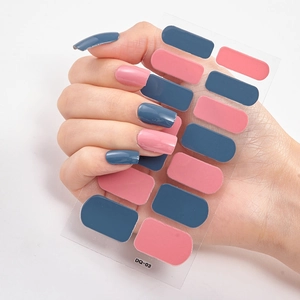 Close-up of 3D laser gold nail stickers in navy blue and pink on a hand, model DQ-03