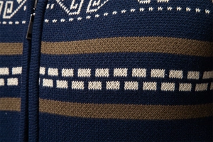 Detail of army green cardigan featuring geometric jacquard patterns and a metal zipper