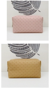 Detail of woven texture toiletry bags in pink and beige with secure zippers
