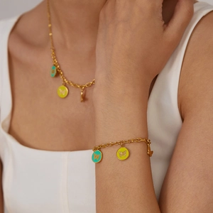 Gold stainless steel jewelry set featuring butterfly enamel pendants on necklace and bracelet
