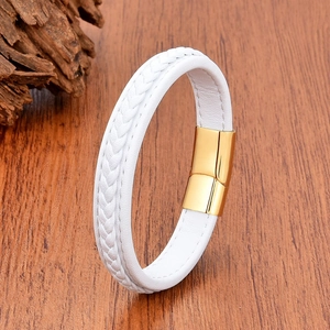 Close-up of white braided leather bracelet with a polished gold magnetic clasp on wood