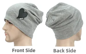 Detail view of grey knitted beanie with heart leather patch and Drema logo embroidery
