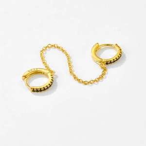 Detail of S925 sterling silver double piercing hoop earring with gold chain and black stones