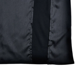 Detailed macro view of black lace stitching and satin fabric texture on this dress