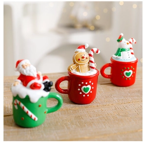 Detailed close-up of mini resin Santa, Gingerbread man and Snowman cup decorations