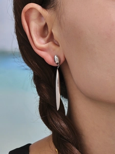 Close-up of elegant silver teardrop earrings on model with polished finish and modern style