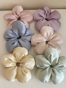 Close-up of premium satin flower scrunchies in six soft Morandi colors on white backdrop