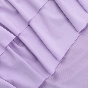 Macro shot of layered lavender purple mesh fabric with detailed ruffled texture on a dress
