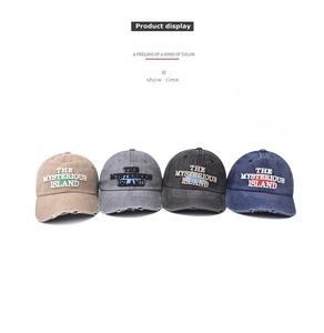 Detail of four distressed cotton baseball caps with Mysterious Island embroidery