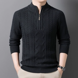 Detail of men's quarter-zip sweater showing cable knit texture and metal zipper closure